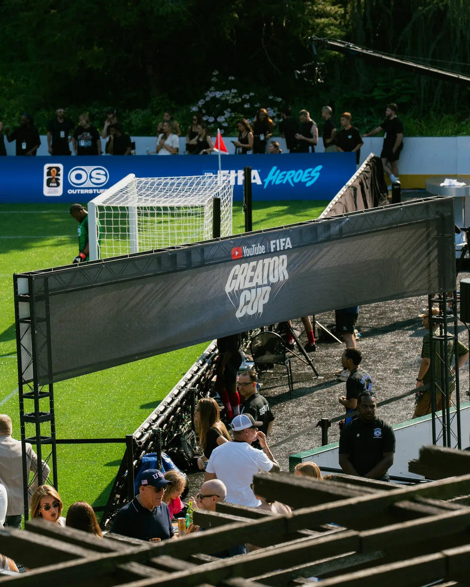 The Creator Cup pitch in Central Park with the YouTube FIFA Creator Cup gantry and fans in the stands
